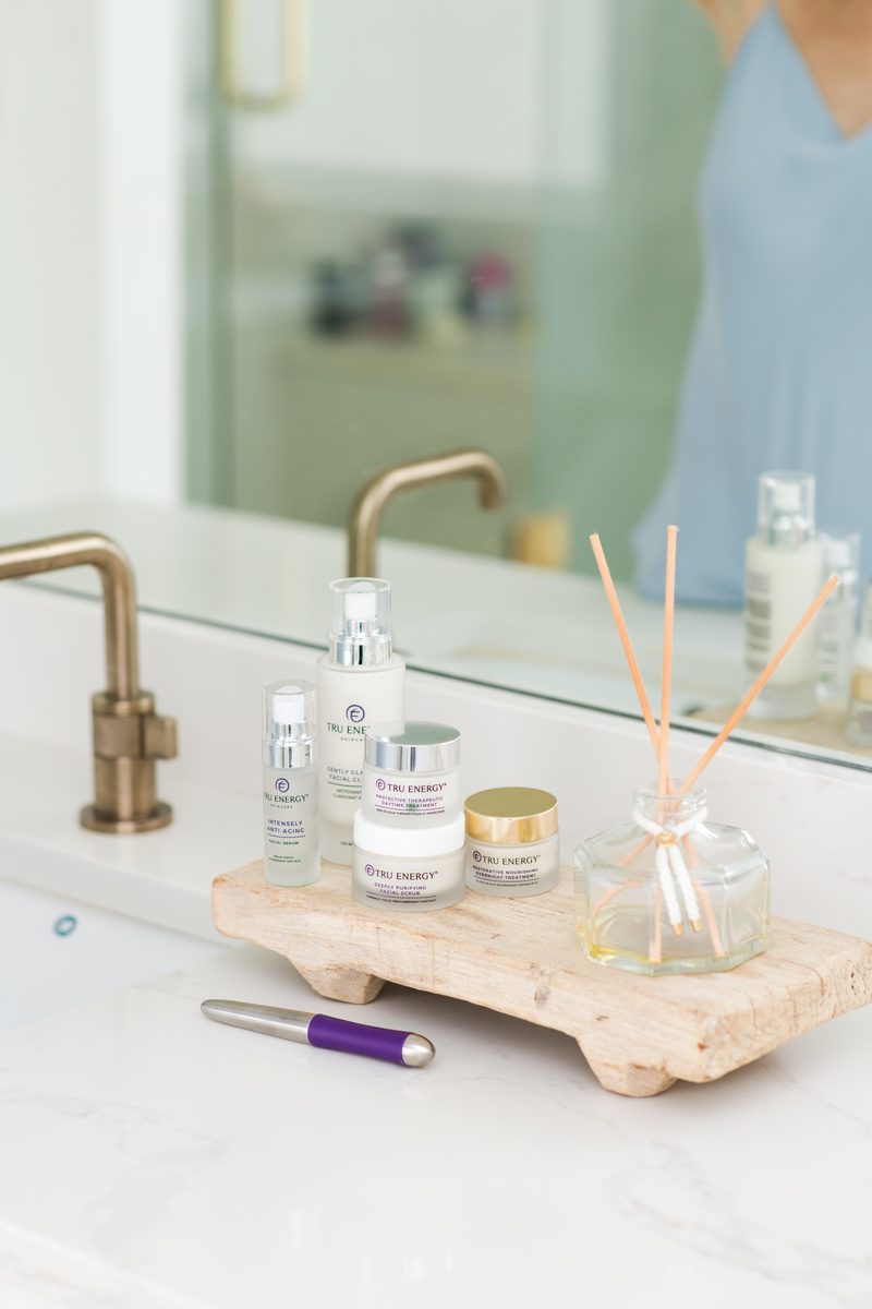 Tru Energy skincare collection arranged on a marble vanity